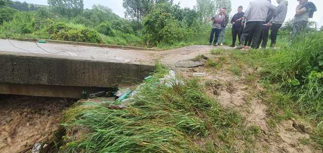 Dolj: Gospodării izolate, după ce apele unui pârâu au distrus un pod / Trei persoane au fost evacuate - FOTO