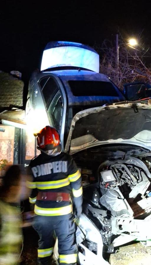 Un autoturism a ieşit de pe şosea şi a ajuns pe acoperişul unei case, într-un sat din Prahova/ Cele patru persoane din maşină şi persoana aflată în locuinţă au scăpat fără răni - FOTO