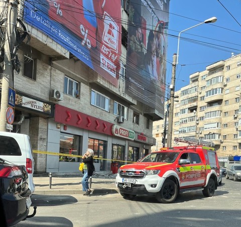 Mesh publicitar desprins de pe faţada unui bloc din Timişoara, cu tot cu plăcile de beton care au cedat, ajungând pe trotuar / Fritz: Cineva a dat găuri /  Cineva putea fi acolo în acel moment / Firma mai fusese amendată - FOTO