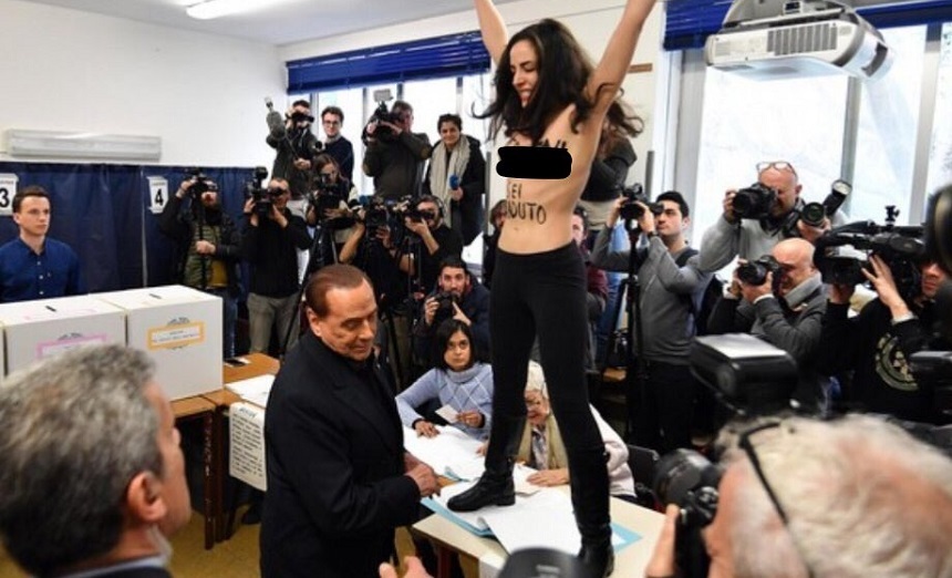 Alegeri în Italia: O femeie topless a protestat faţă de Berlusconi numindu-l „expirat”; peste 200 de secţii de votare erau încă închise la două ore de la începerea votului - VIDEO

